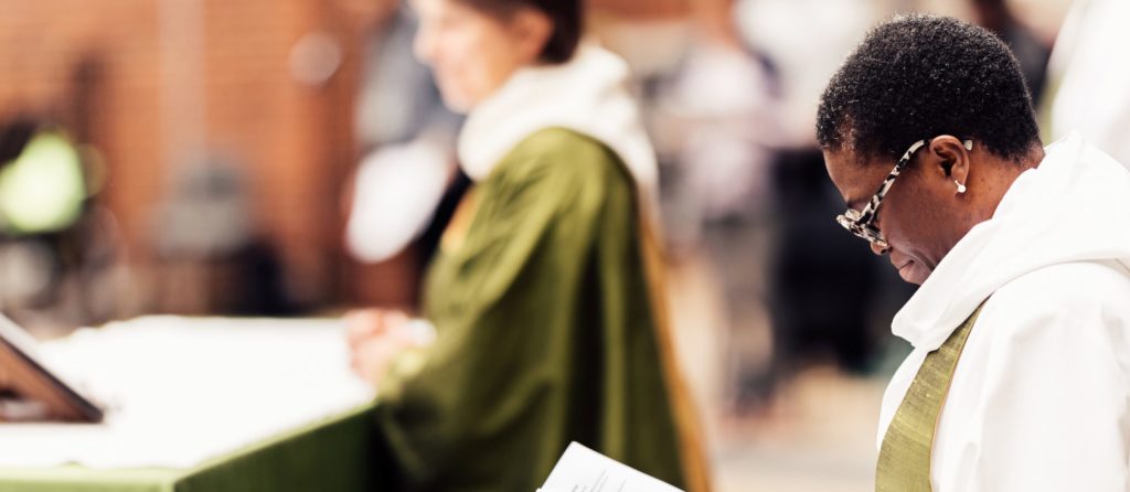 two female priests in a church service