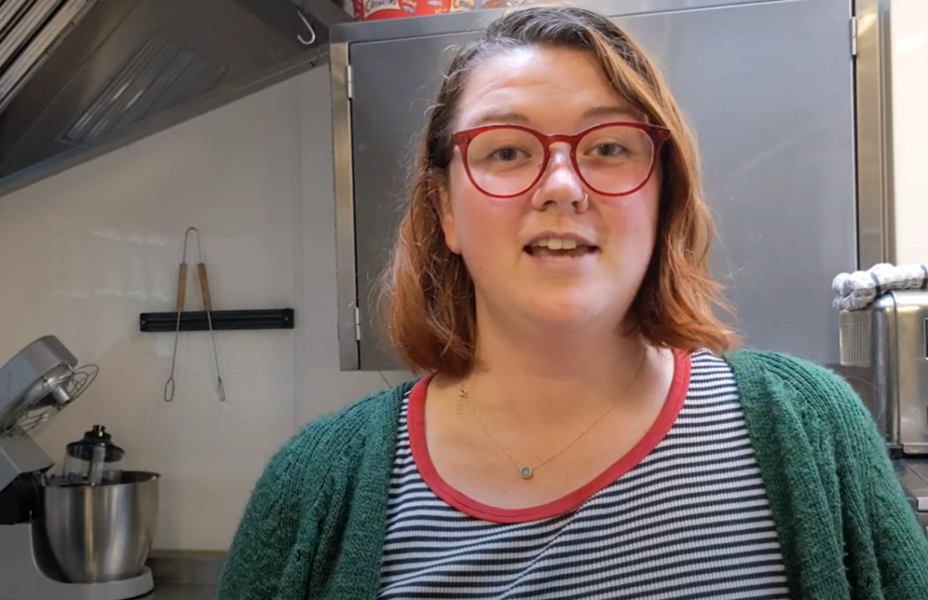 a woman speaking in a kitchen