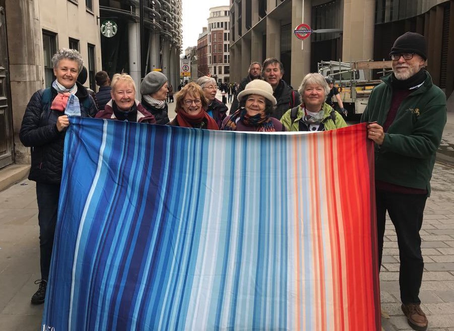 10 Earth Justice warriors holding a banner