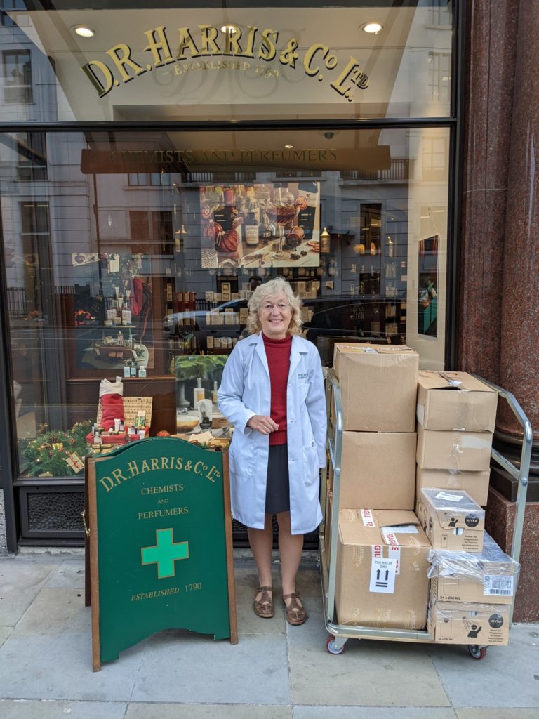 Alison standing in front of her shop with gift bags